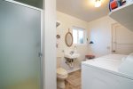 The mud room has a step-in shower and washer  dryer.
